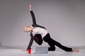 A ballerina dressed in a business suit poses for a laptop and drinks coffee. Flexible woman works at the computer Royalty Free Stock Photo