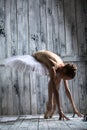 Ballerina dressed in white tutu makes lean forward Royalty Free Stock Photo