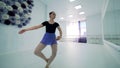Ballerina is executing dancing movements in a studio