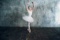 Ballerina female. Young beautiful woman ballet dancer, dressed in professional outfit, pointe shoes and white tutu. Royalty Free Stock Photo