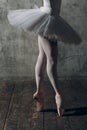 Ballerina female. Young beautiful woman ballet dancer, dressed in professional outfit, pointe shoes and white tutu. Royalty Free Stock Photo