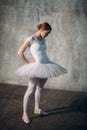 Ballerina female. Young beautiful woman ballet dancer, dressed in professional outfit, pointe shoes and white tutu. Royalty Free Stock Photo