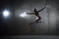 Ballerina in a jump with flour on a gray background. Royalty Free Stock Photo