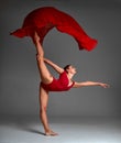 Ballerina Jumping in Pointe Shoes with Flying Red Cloth, Modern Ballet Dance,  Gray Background Royalty Free Stock Photo