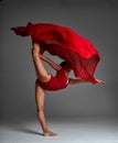 Ballerina Jumping in Pointe Shoes with Flying Red Cloth, Modern Ballet Dance, Isolated Gray Background Royalty Free Stock Photo