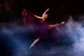 Ballerina with long dress jumping on the stage Royalty Free Stock Photo