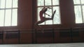 Ballerina performs acrobatics tricks in studio