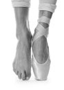 Ballerina in pointe shoe dancing, closeup. Black and white effect