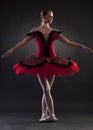 Ballerina posing on black background