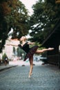 Ballerina posing in the center city