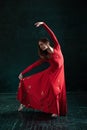 Ballerina posing in pointe shoes at black wooden pavilion Royalty Free Stock Photo