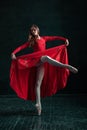 Ballerina posing in pointe shoes at black wooden pavilion Royalty Free Stock Photo