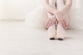 Ballerina puts on pointe ballet shoes, graceful legs