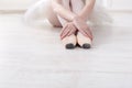 Ballerina puts on pointe ballet shoes, graceful legs Royalty Free Stock Photo