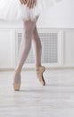 Ballerina puts on pointe ballet shoes, graceful legs Royalty Free Stock Photo