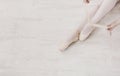 Ballerina puts on pointe ballet shoes, graceful legs Royalty Free Stock Photo