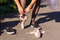 Ballerina puts pointes on her feet outdoors Royalty Free Stock Photo