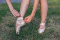 Ballerina puts on pointes on her legs Royalty Free Stock Photo