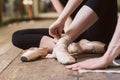 Ballerina putting on her ballet shoes Royalty Free Stock Photo