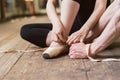 Ballerina putting on her ballet shoes Royalty Free Stock Photo