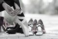 Ballerina Putting Pointe Ballet Shoes on her Feet