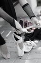 Ballerina Putting Pointe Ballet Shoes on her Feet