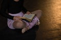 Ballerina reading book while sitting on the stage in theatre Royalty Free Stock Photo