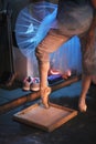 The ballerina rubs the toe of pointe shoes in a box with pounded rosin