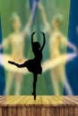 Ballerina silhouette dancing on pointe on stage in the spotlight in attitude derriere postion with two ballerinas on the backgroun Royalty Free Stock Photo