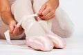 Ballerina sit down on floor to put on slippers prepare for perf Royalty Free Stock Photo