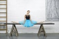 Ballerina sits on split in studio