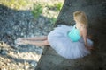 Ballerina sitting on the edge of bridge