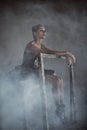 Ballerina sitting in the smoke