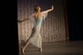 Ballerina on stage. The dancer does the pa. A girl in a blue and white dress