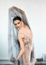 Ballerina in stage long transparent costume dancing modern ballet.