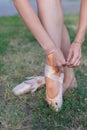 Ballerina puts on pointes on her legs Royalty Free Stock Photo