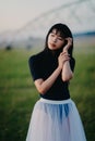 Ballerina stands in field on background of agricultural sprayer Royalty Free Stock Photo