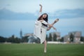 Ballerina stands in pose of swallow on lawn. Royalty Free Stock Photo