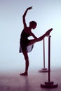 Ballerina stretching on the bar