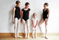 Ballerina superstar in the making. a group of young ballerinas teaching a little girl ballet in a dance studio. Royalty Free Stock Photo