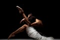 Ballerina with a tutu posing on the floor