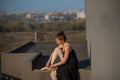 Ballerina in a tutu posing near the fence. Beautiful young woman wearing a black dress and wearing pointe shoes outside. Gorgeous Royalty Free Stock Photo