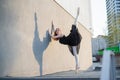 Ballerina in tutu posing standing near the wall. Beautiful young woman in black dress and pointe dancing outside Royalty Free Stock Photo