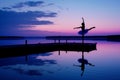 ballerina twirling on a reflective dock at dawn Royalty Free Stock Photo