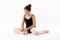 Ballerina tying the laces on her ballet shoes