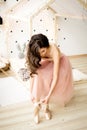 Ballerina tying pointe shoes