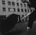 Ballerina with umbrella on city street