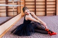 Ballerina Wearing black Tutu Doing exercise in training hall. Royalty Free Stock Photo