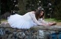 Ballerina wearing white dress and point shoes dancing ballet outdoors Royalty Free Stock Photo