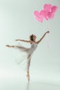 ballerina in white dress dancing with pink balloons Royalty Free Stock Photo